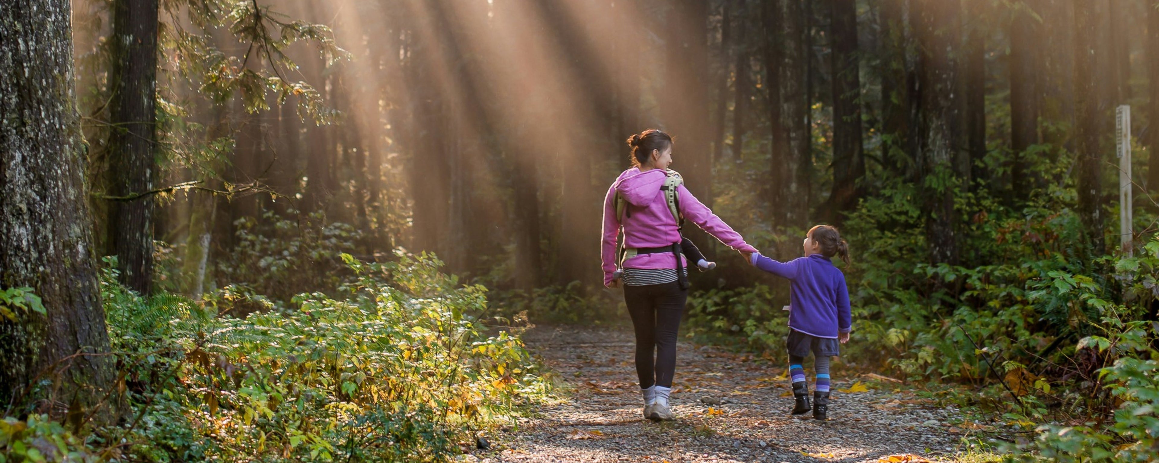 photo of mum and child walking in forest